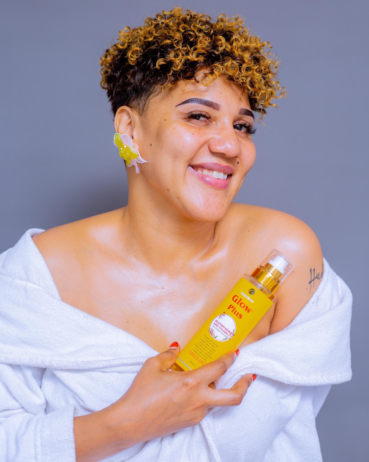 Smiling customer holding Glow Plus Oil
